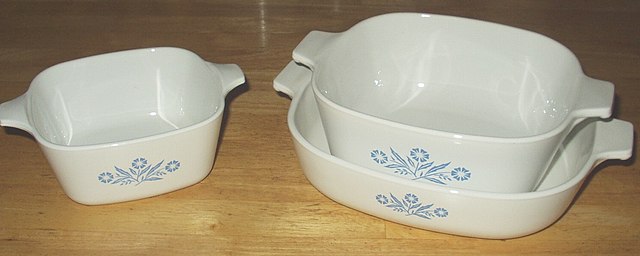 Three Corningware
dishes. The one on the left is small and square.